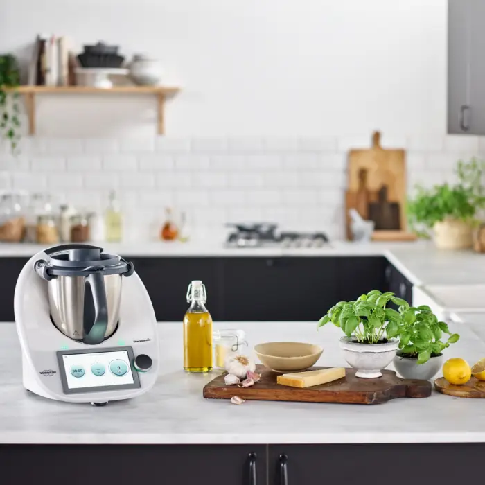 Thermomix on the kitchen counter with herbs and spices