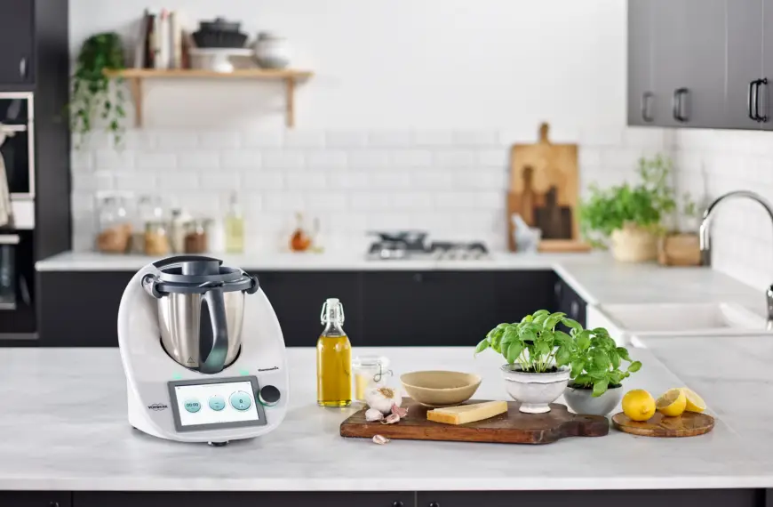 Thermomix on the kitchen counter with herbs and spices