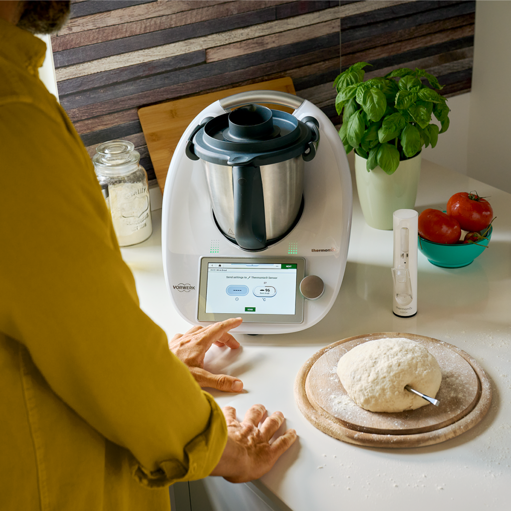 Thermomix on the kitchen counter with a sensor and dough