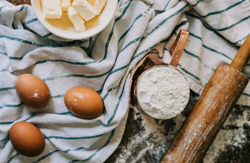 Flour, eggs, butter with a rolling pin and a cloth